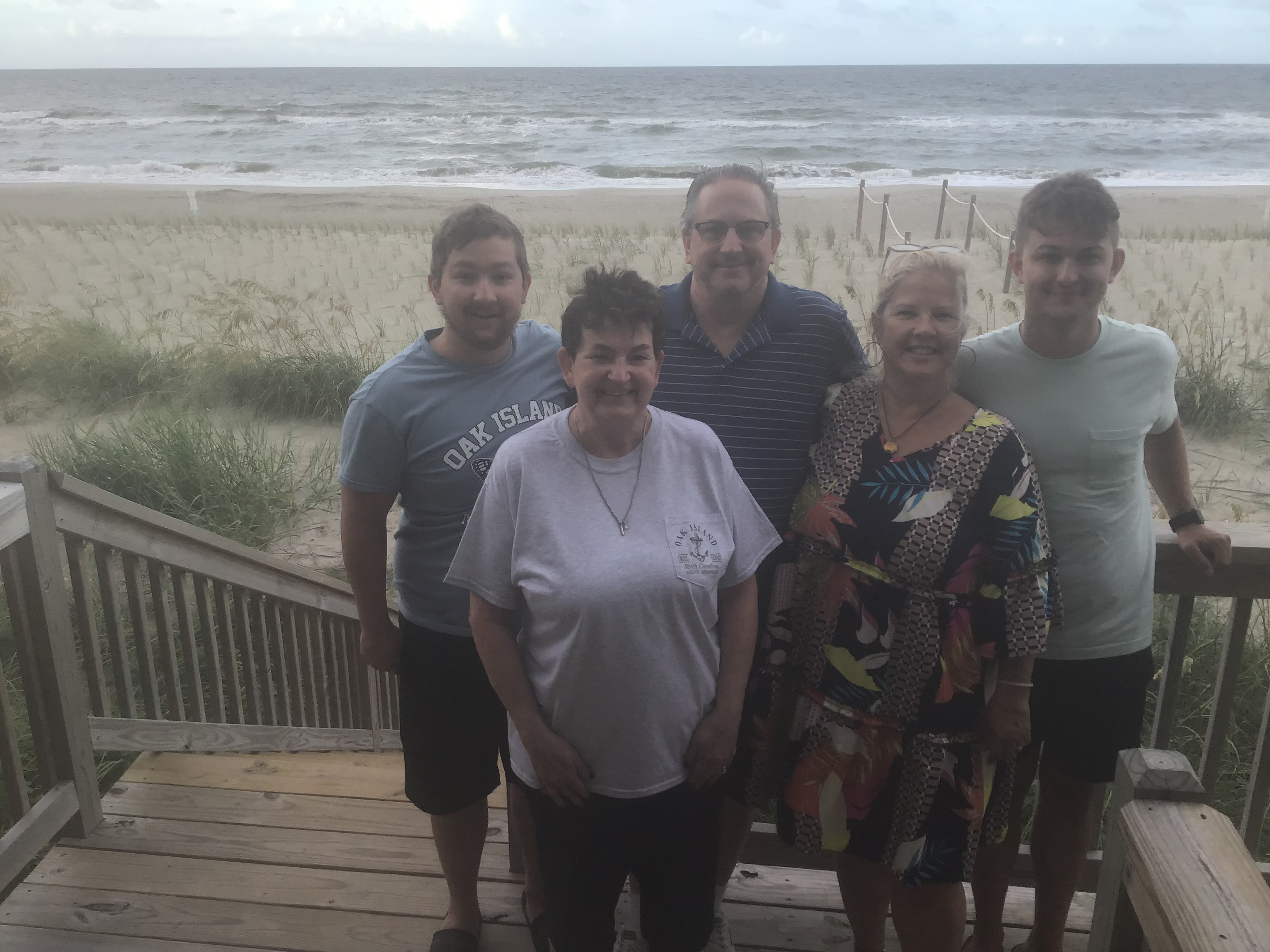 FInal Pic on the deck before saying goodbye.  L2R Josh Curtis, Julane Crabtree, Gene Curtis, Odalie Curtis, Jack Curtis                               Location:  Sandpiper Cottage, Oak Island, NC                                 Source: Julane Crabtree                                Date: 28 Jul 2023