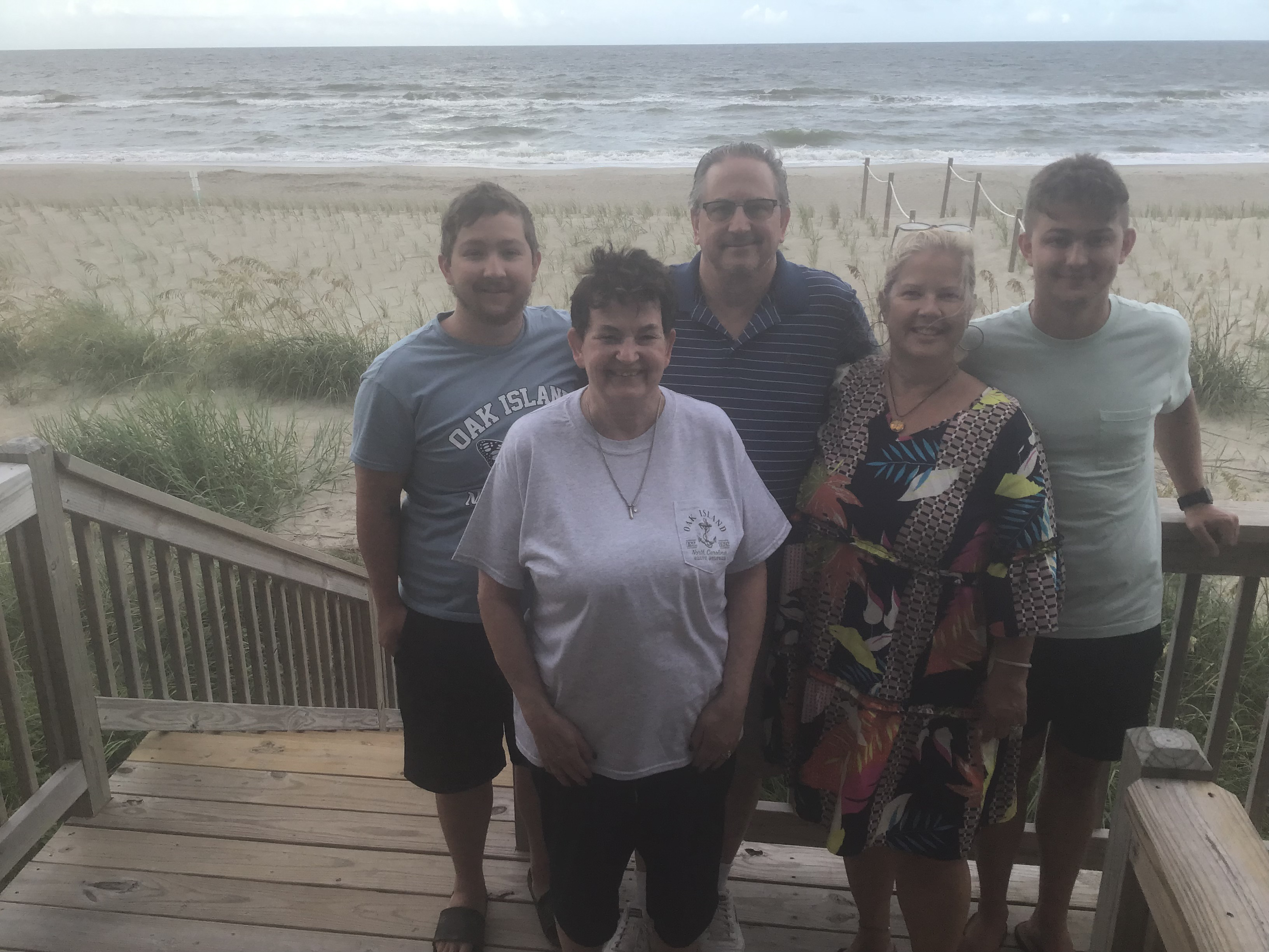 FInal Pic on the deck before saying goodbye.  L2R Josh Curtis, Julane Crabtree, Gene Curtis, Odalie Curtis, Jack Curtis                               Location:  Sandpiper Cottage, Oak Island, NC                                 Source: Julane Crabtree                                Date: 28 Jul 2023