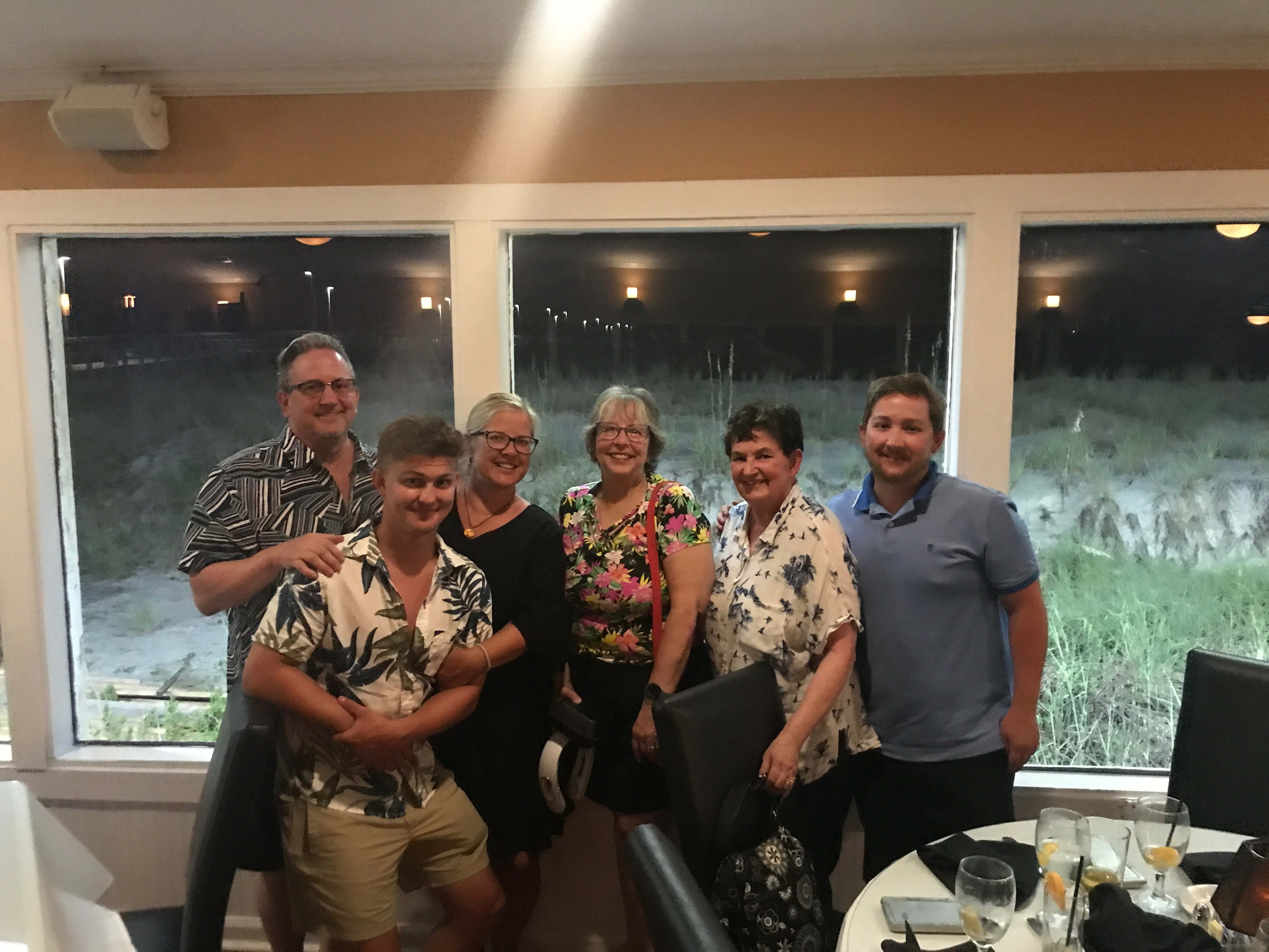 Enjoying dinner at Island Way in NC   L2R: Gene Curtis, Jackson Curtis, Odalie Curtis, Mavis McCollam, Julane Crabtree, Josh Curtis     Location:  Island Way, Oak Island NC                                Source: Odalie Curtis                                Date: 27 Jul 2023