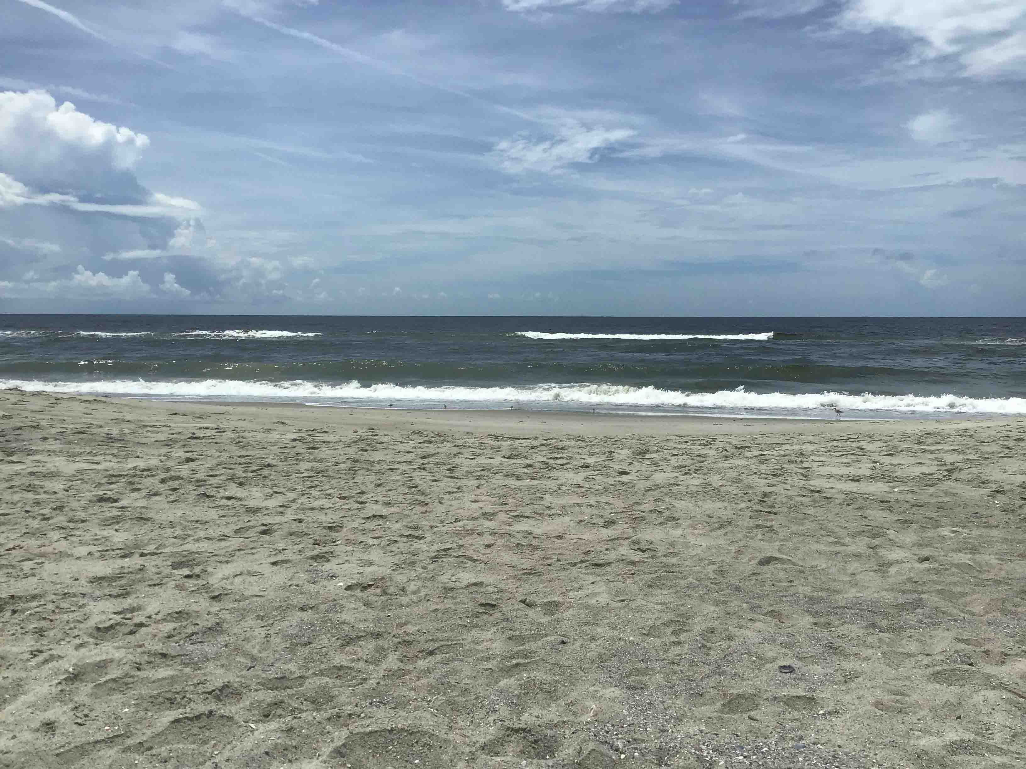View of the Ocean - a very calm ocean for most of the week.          Location:  Sandpiper Cottage, Oak Island NC                                 Source:  Julane Crabatree                               Date:28 Jul 2023